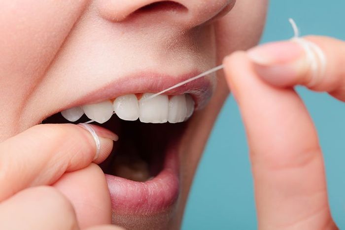 woman flossing up close