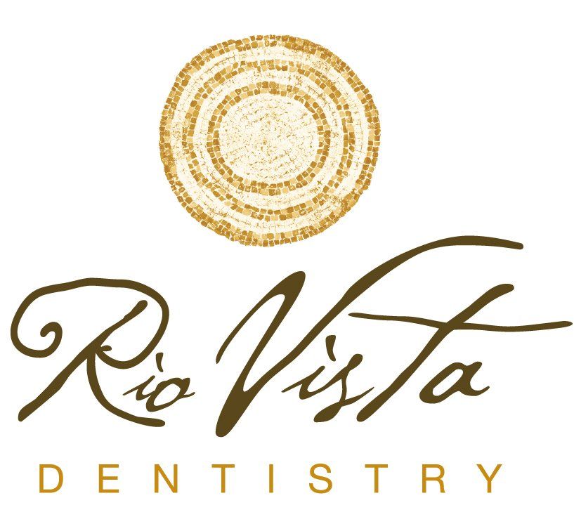 Rio Vista Dentistry logo with gold circular emblem and brown script text on white background