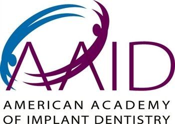 American Academy of Implant Dentistry logo in blue and purple with stylized arcs and text