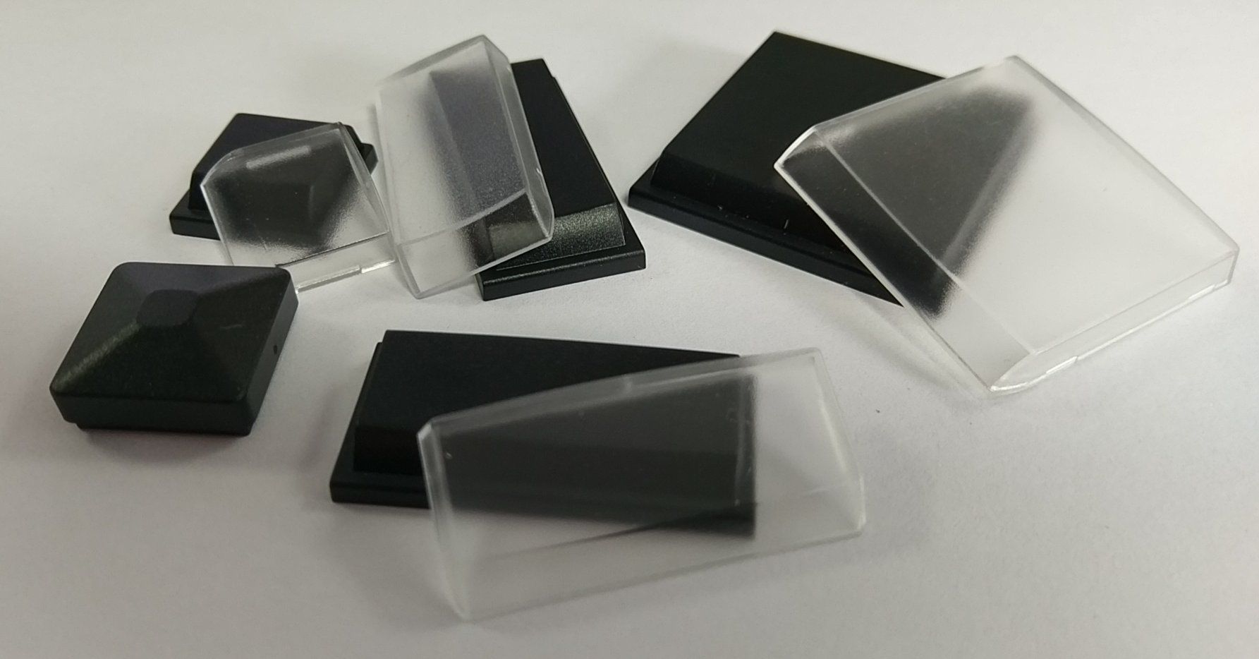 A group of plastic boxes are sitting on top of each other on a white surface.