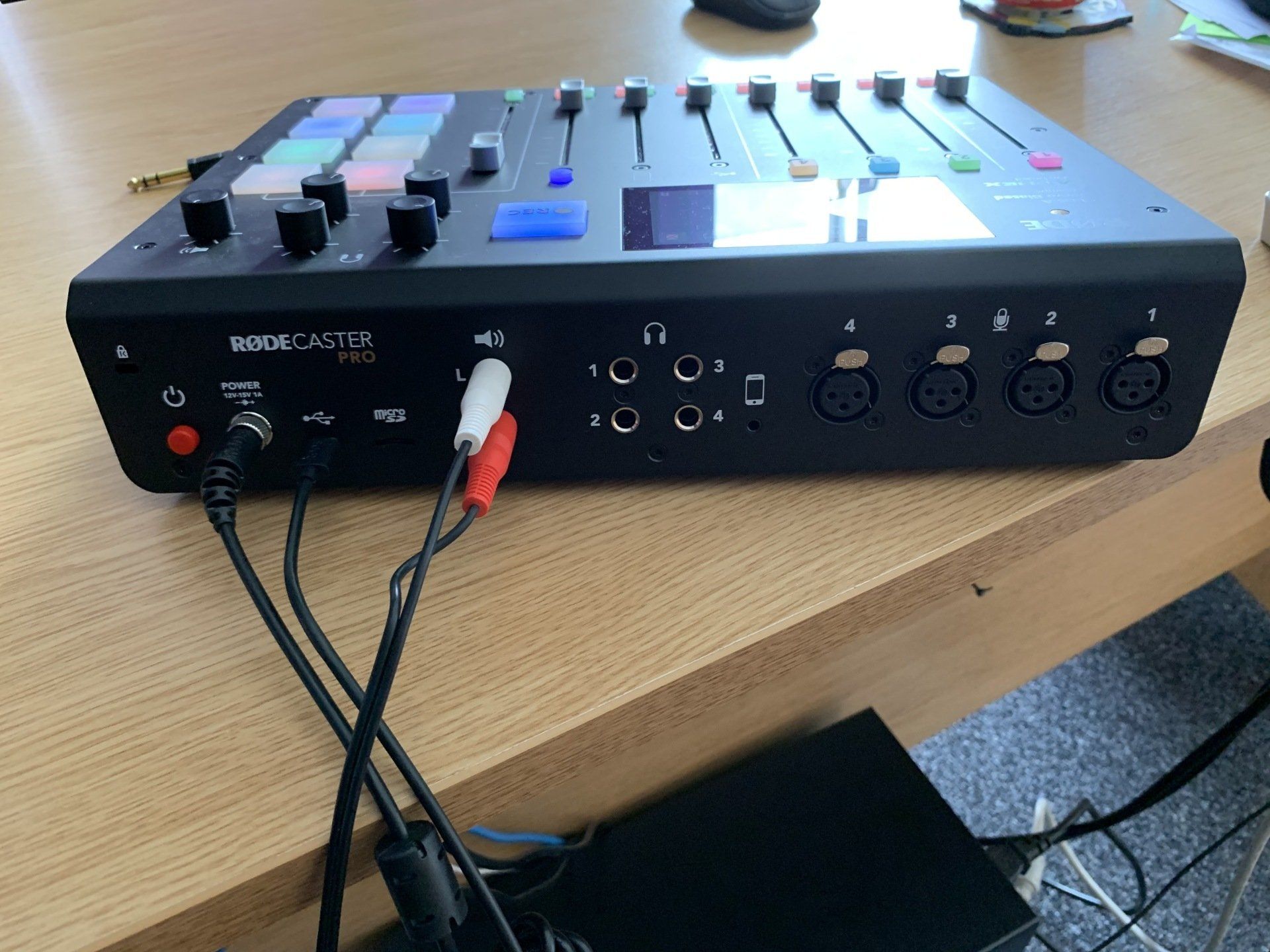 A sound mixer is sitting on a wooden table
