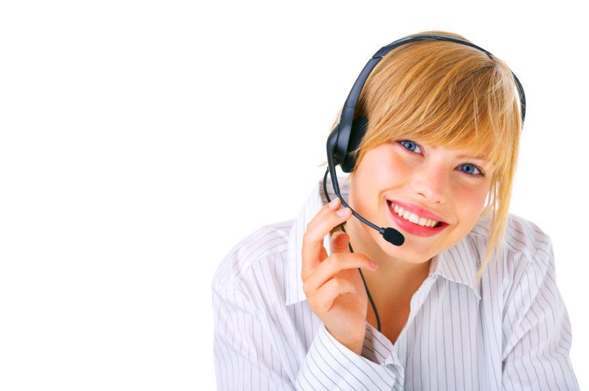 A woman wearing a headset is smiling for the camera