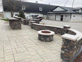 There is a round fire pit in the middle of the patio