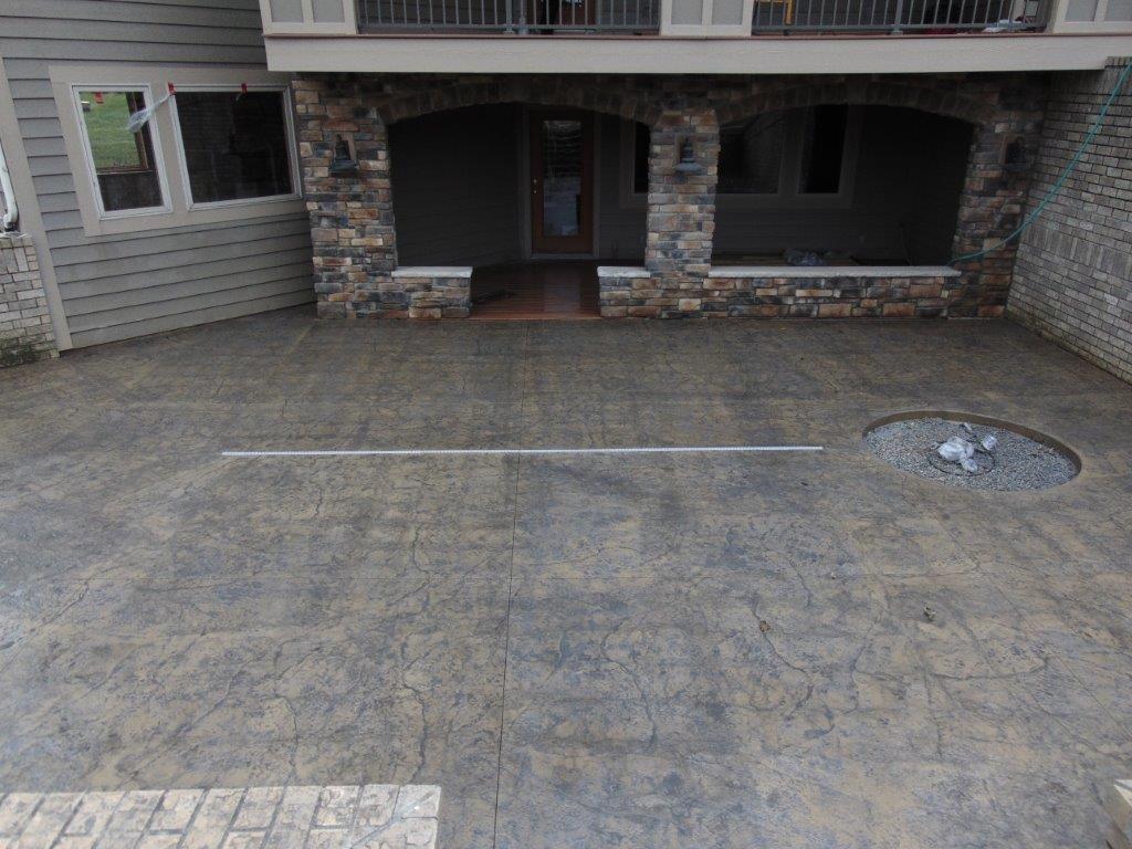 A concrete patio with a fire pit for camping