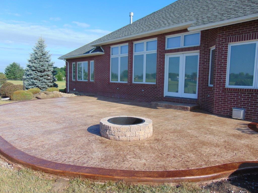 A beautiful brick house with a fire pit in front of it