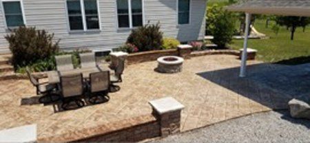 An aerial view of a patio with a table and chairs and a fire pit