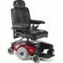 Red and black electric wheelchair with a cushioned seat and joystick controller.
