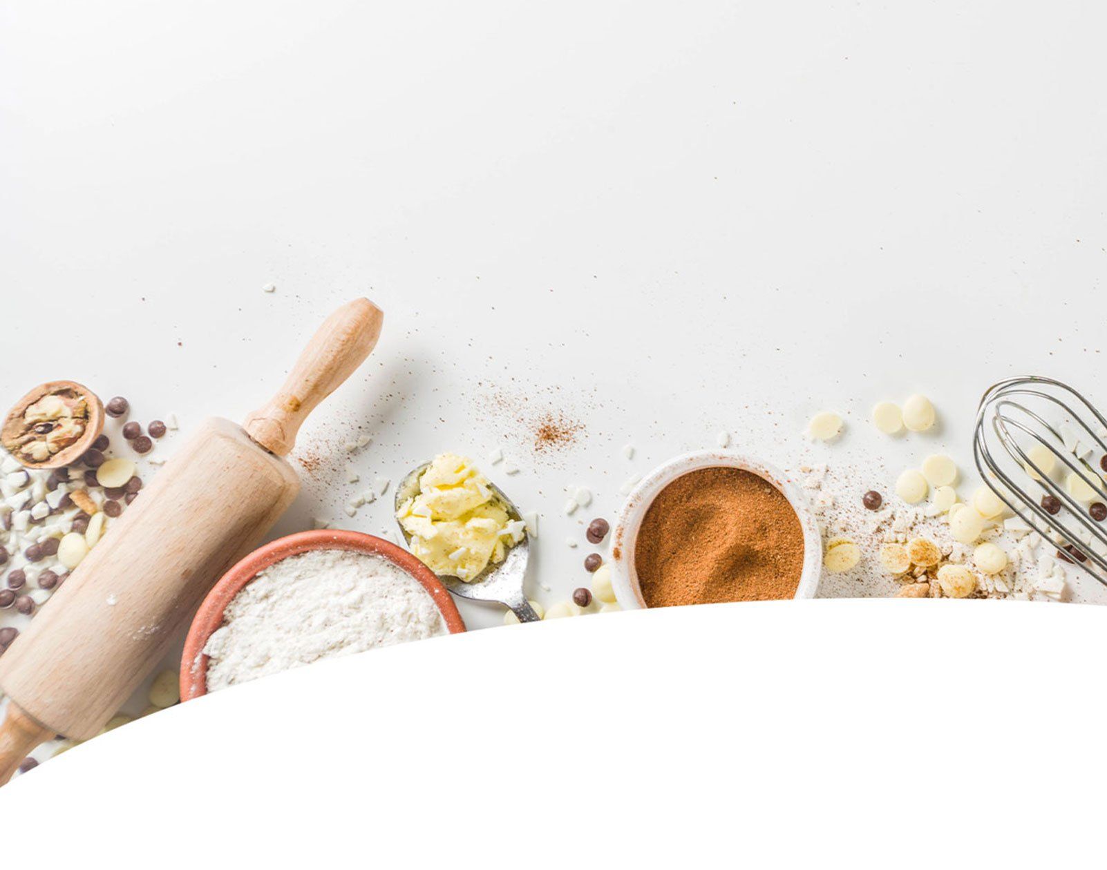 rolling pin, flour, spices and whisk on table