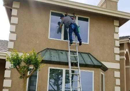 window cleaner on a ladder