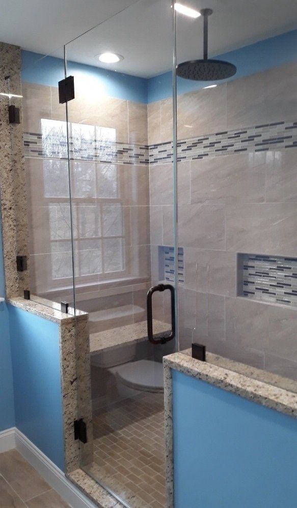 A bathroom with a walk in shower and a toilet.