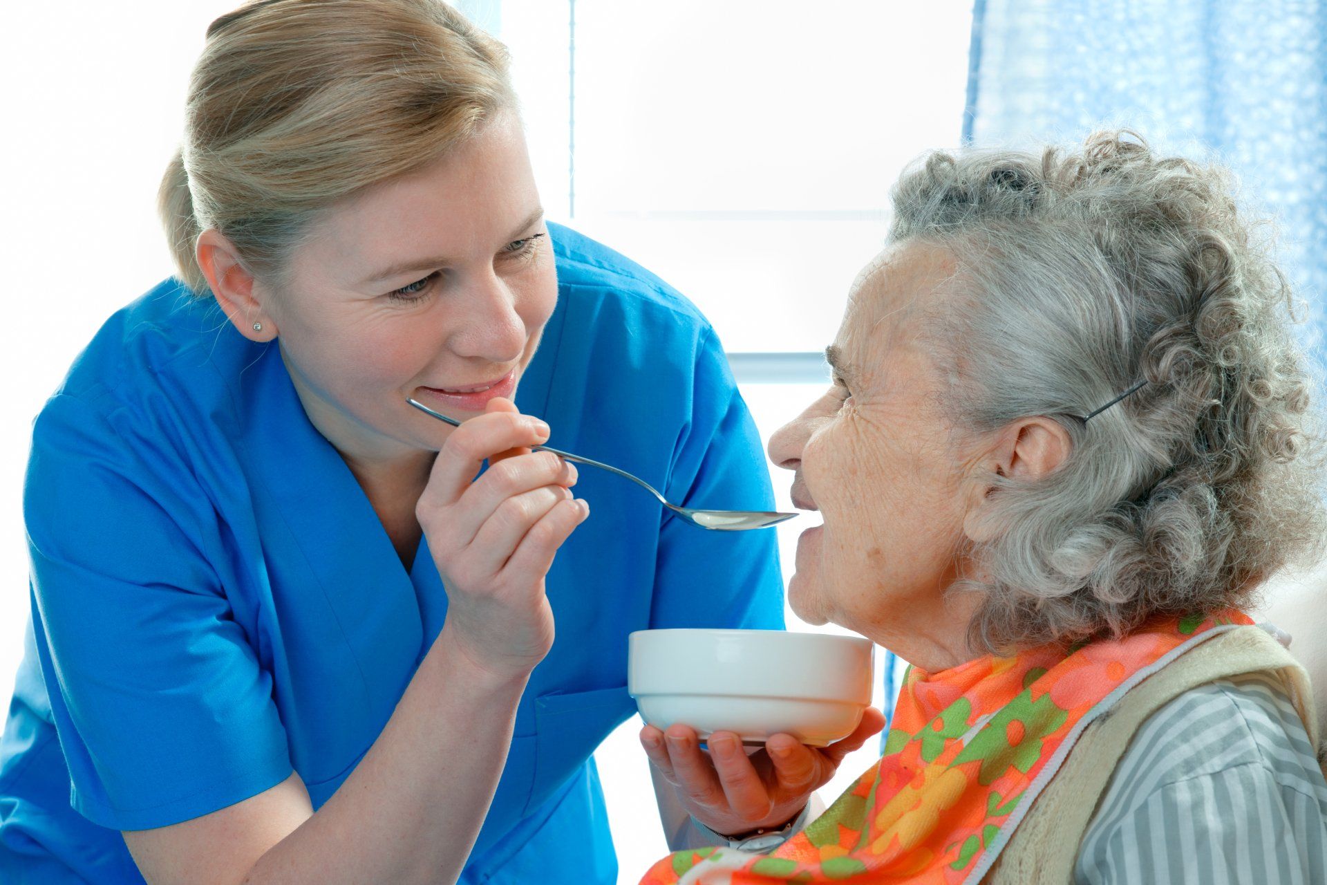 Housekeeping Services — Nurse Feeding Senior Woman in Columbus, OH