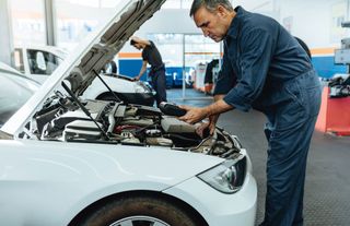 Vehicle Maintenance — Mechanic with Diagnostic Device in Kokomo, IN Vehicle Maintenance — Mechanic with Diagnostic Device in Kokomo, IN