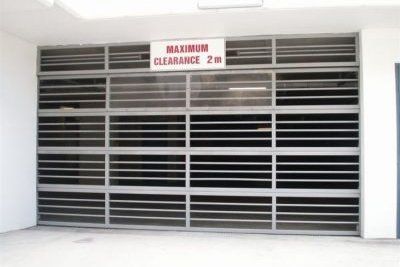 commercial bar panel garage door with max clearance sign