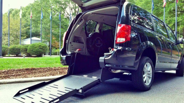 A van with a ramp attached to the back of it.