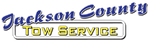 Jackson County Tow Service logo in blue and gold text on a white background