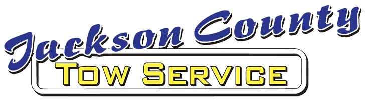 Jackson County Tow Service logo in blue and gold text on a white background