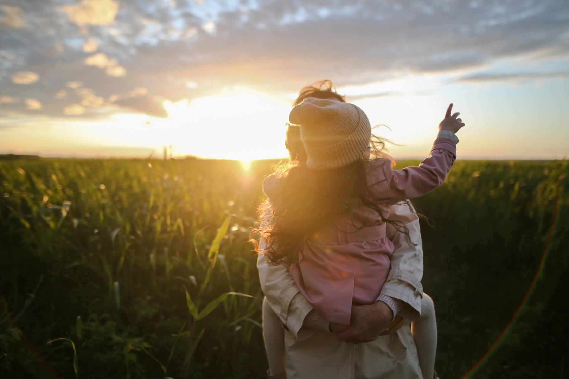 Child being carried in a field near a holiday park in Somerset.