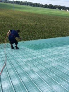 Roof Coating — Man Coating Roof in Lititz, PA