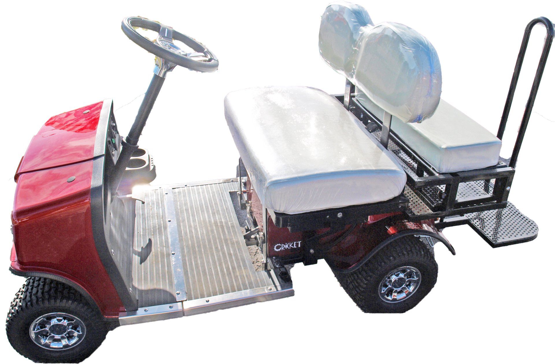 A red golf cart with white seats and a steering wheel