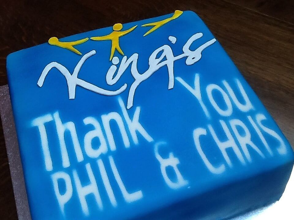 A blue cake that says thank you phil and chris