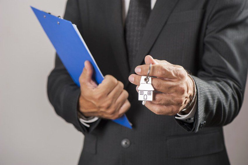 man handing over house keys