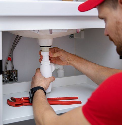 Plumber Installing Sink Siphon — Edgewater, FL — Coleman Plumbing