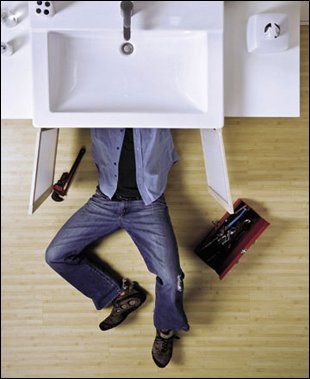 Kitchen plumbing - leicester - MK Plumbing and Heating - Man under sink