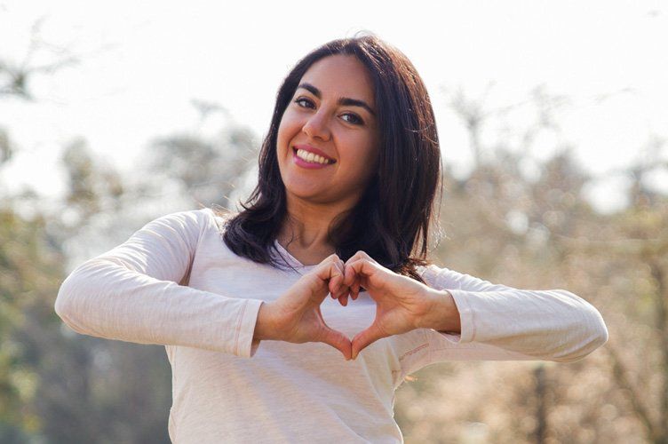 Woman in Round Rock TX making heart sign with hands