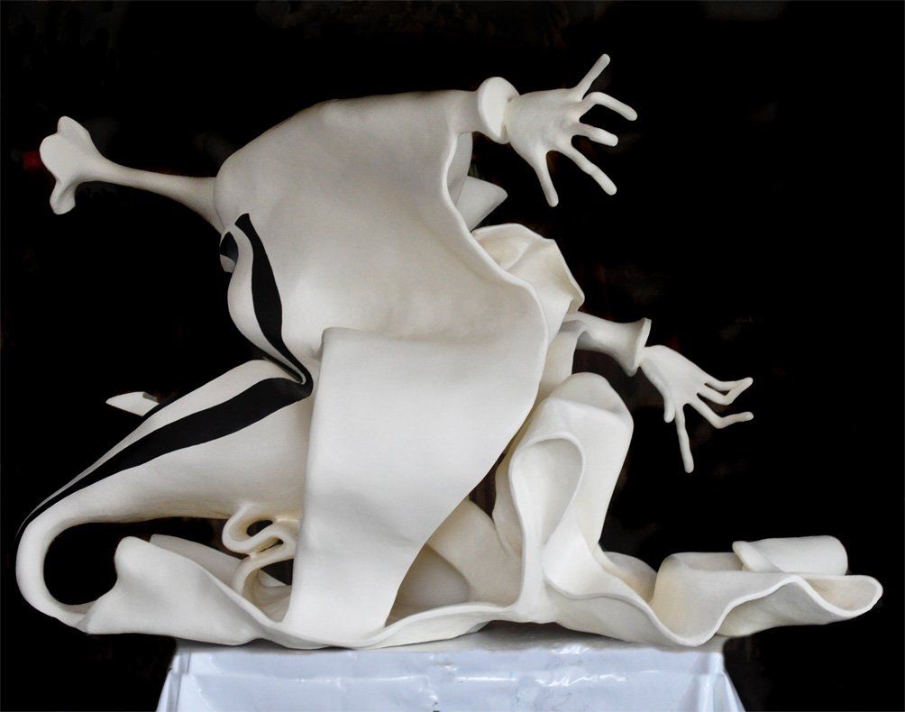 Skulptur aus Pappmasché der Künstlerin Benita von Wendt.
Ansicht: von der Seite rechts.
Die abstrakte Skulptur erinnert an eine Frau die sich zum Kuss nach vorne beugt und sich gleichzeitig zurückzieht. Seitenansicht halbrechts.