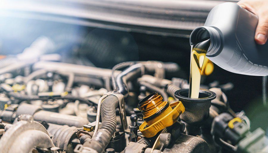 Pouring Oil to Car Engine — Johnstown, PA — S & S Auto Salvage