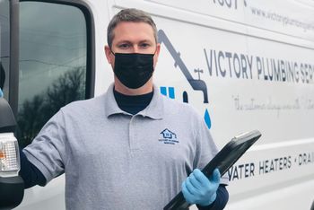Jeff next to van for plumbing specialists Victory Plumber in Bel Air South, MD: owner wearing mask in front of company truck
