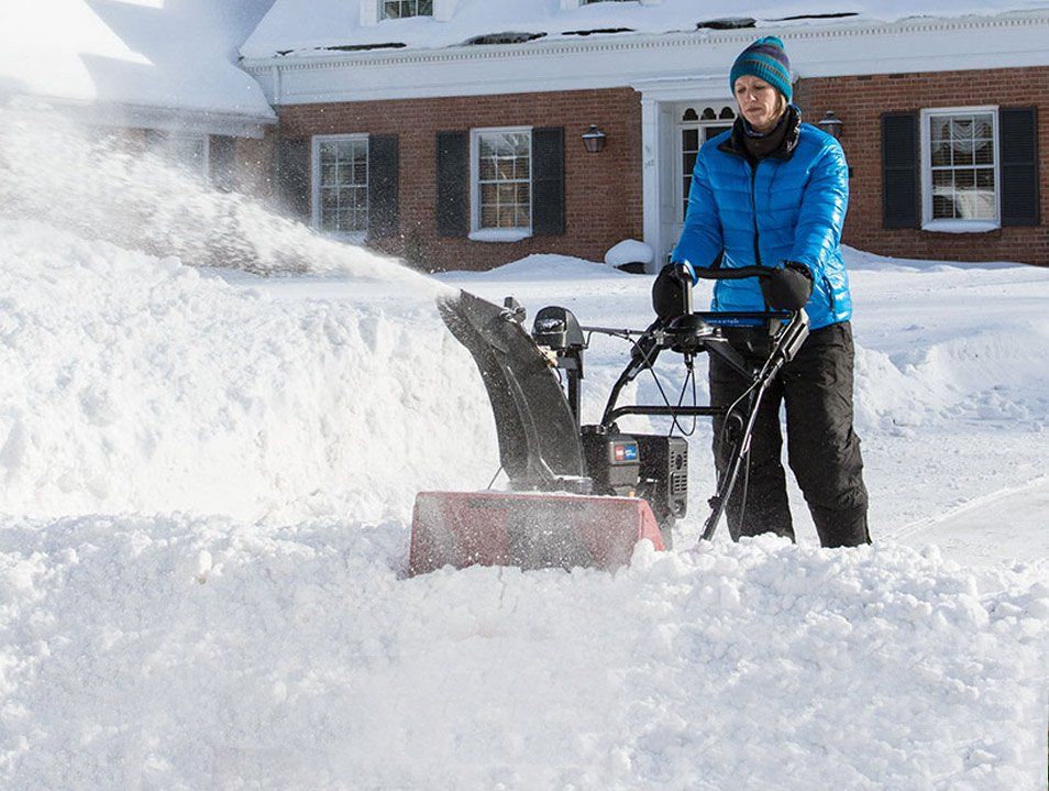 Woman using a Toro Snow Blower