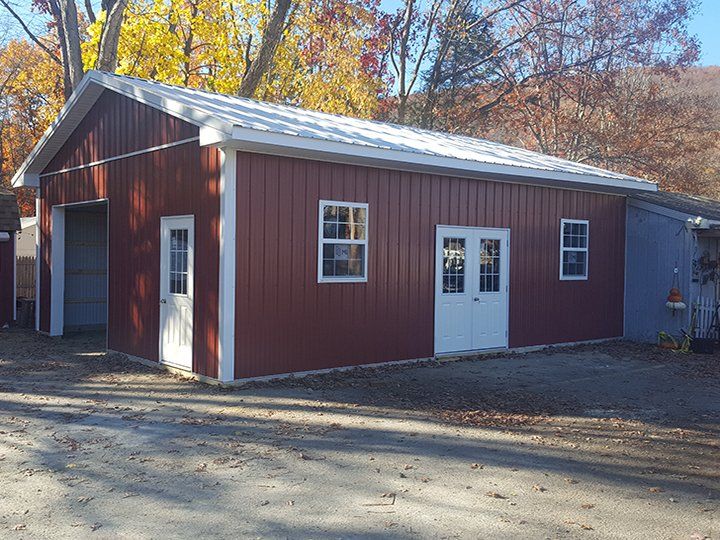 A red barn with white trim and a white roof