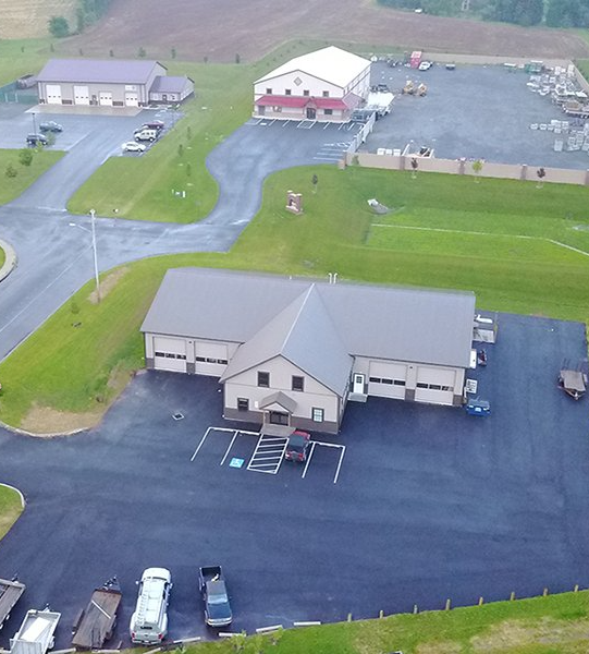 An aerial view of a building with a lot of cars parked in front of it