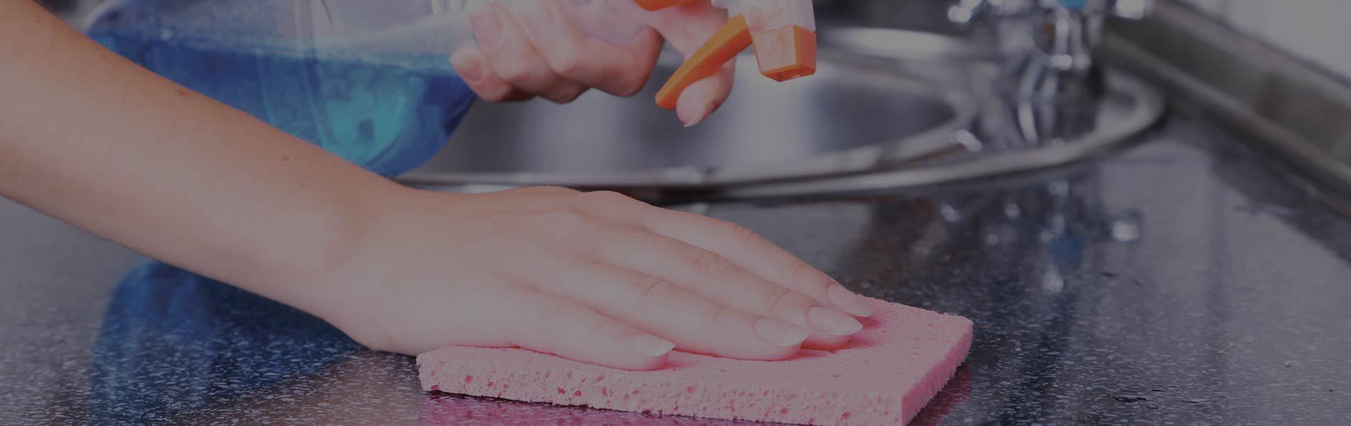 cleaning kitchen with spray and sponge