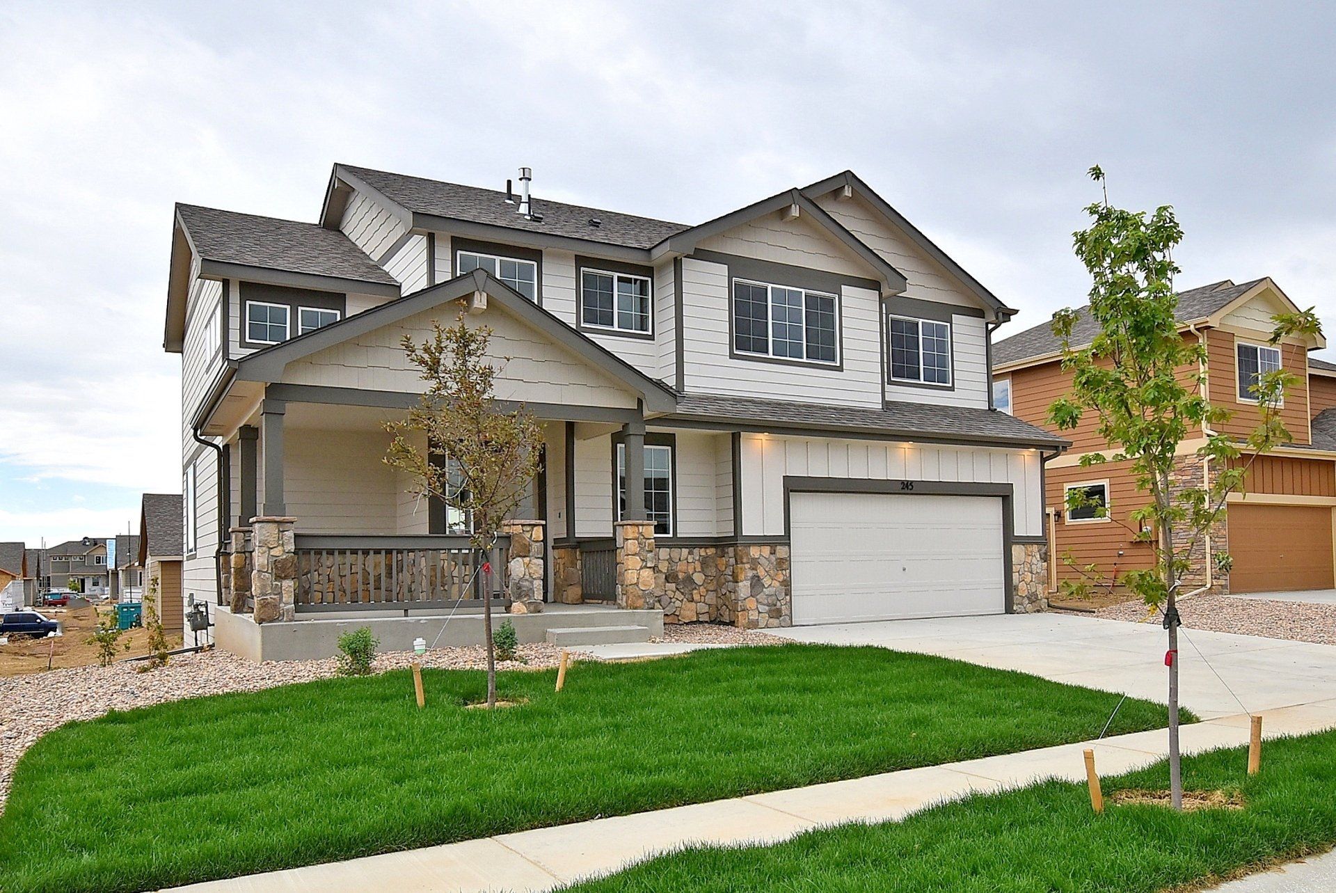 The Saratoga front yard and drive way side view