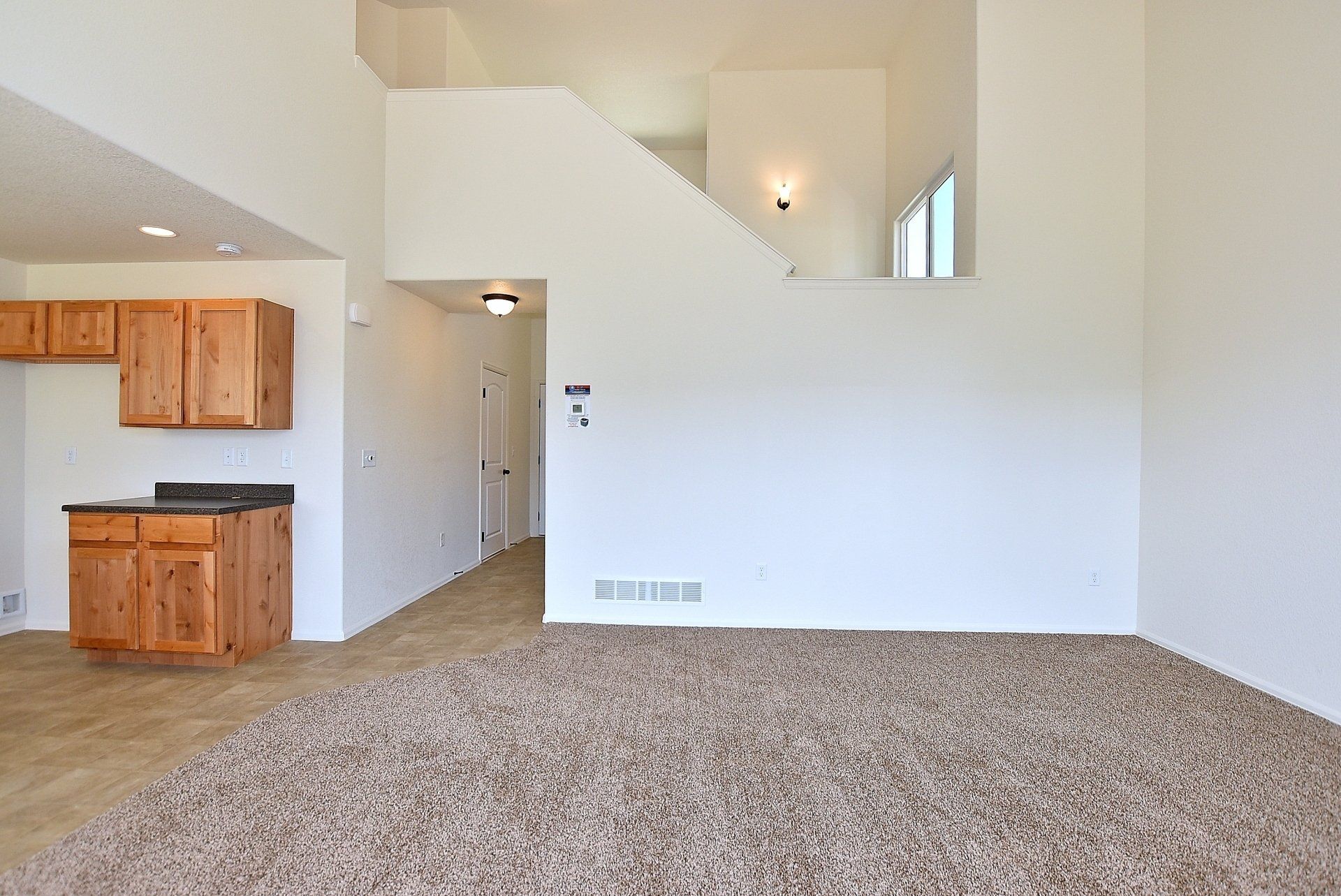 Large open room with doorway and stairs