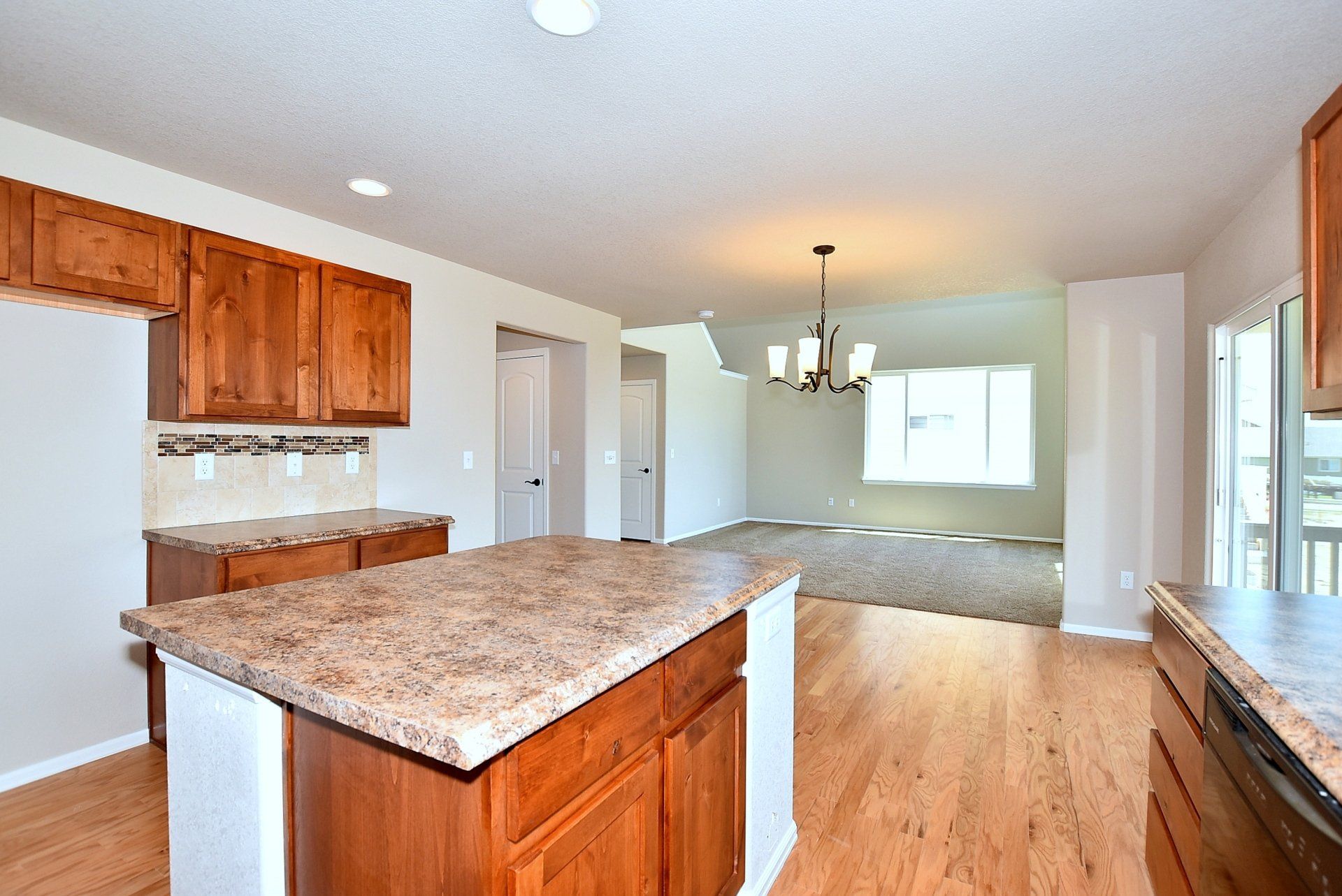 Kitchen with granite center island and wooden floors