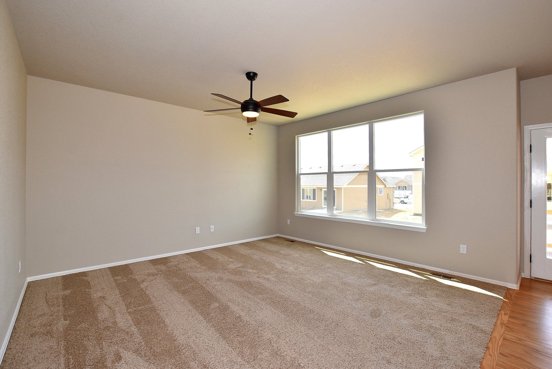 Room with wooden floors and a ceiling fan