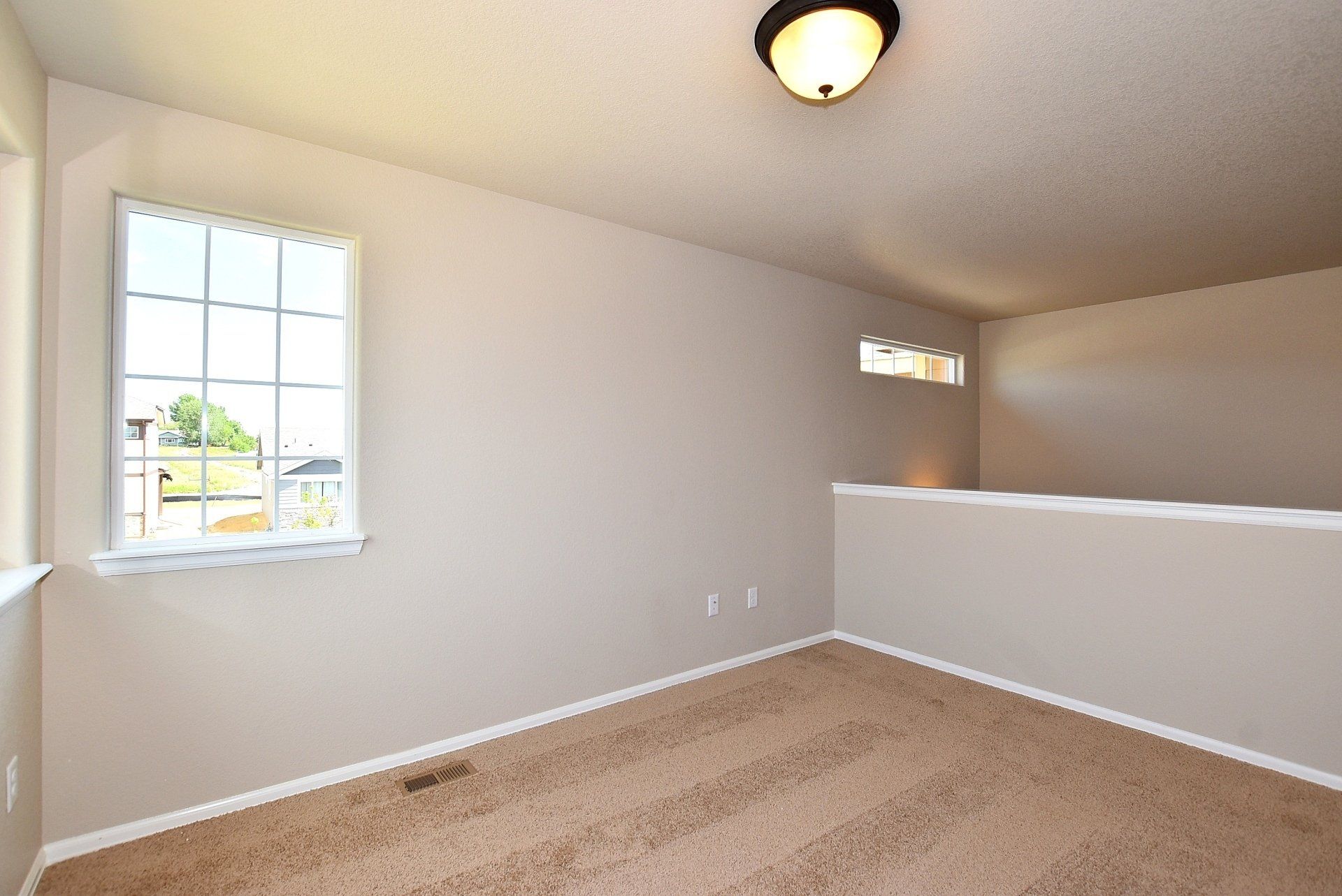 Upsairs room with bannister