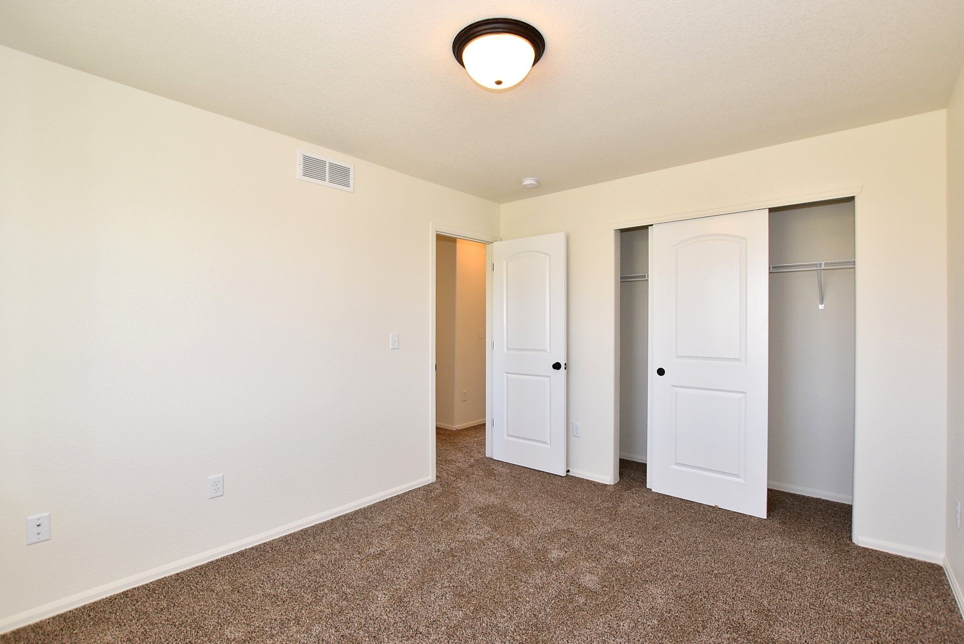 Room with sliding door closet and carpet floors