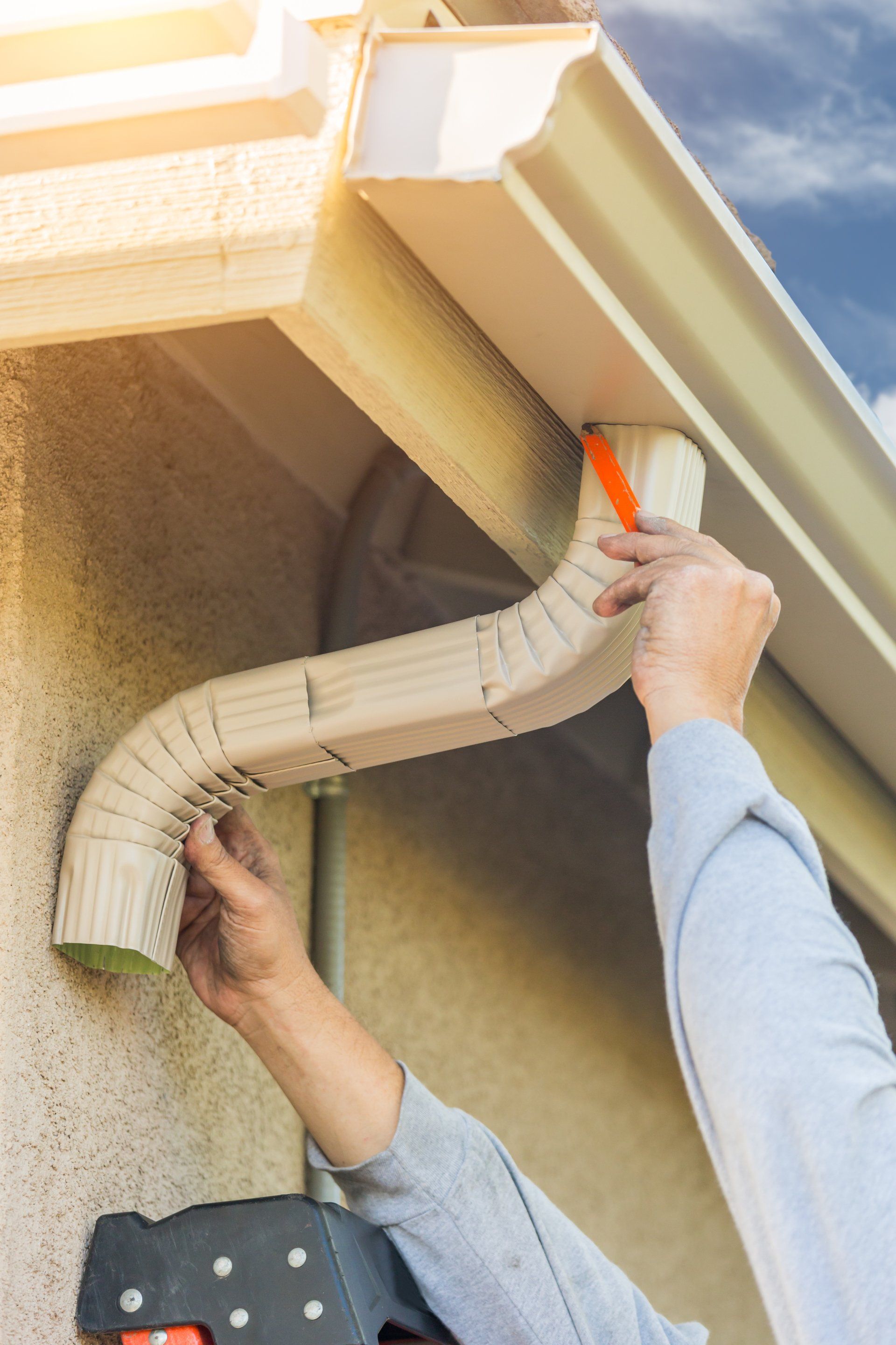 Worker Attaching Aluminum Rain Gutter