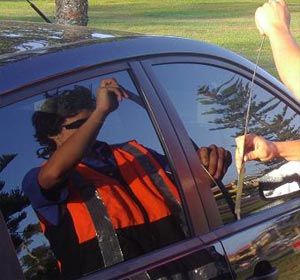 Man Using Tool To Open A Locked Car  — Roadside Assistance in Berkley Vale, NSW