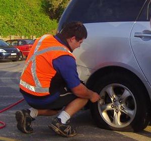 Roadside Assistant Changing Flat Tyre  — Roadside Assistance in Berkley Vale, NSW