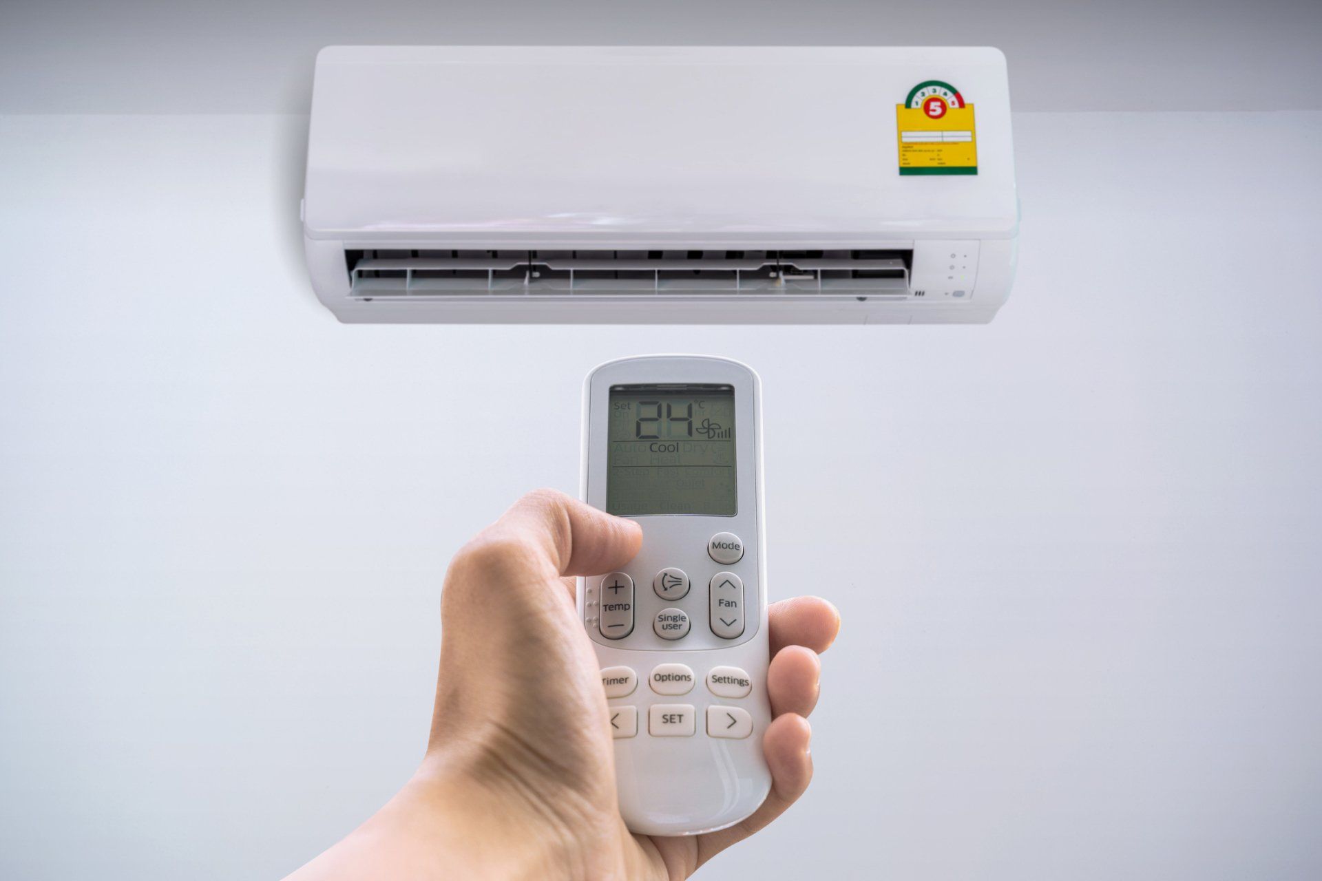 Heating and Cooling — Air Conditioner with Remote Controller in Greensburg, PA Heating and Cooling — Air Conditioner with Remote Controller in Greensburg, PA