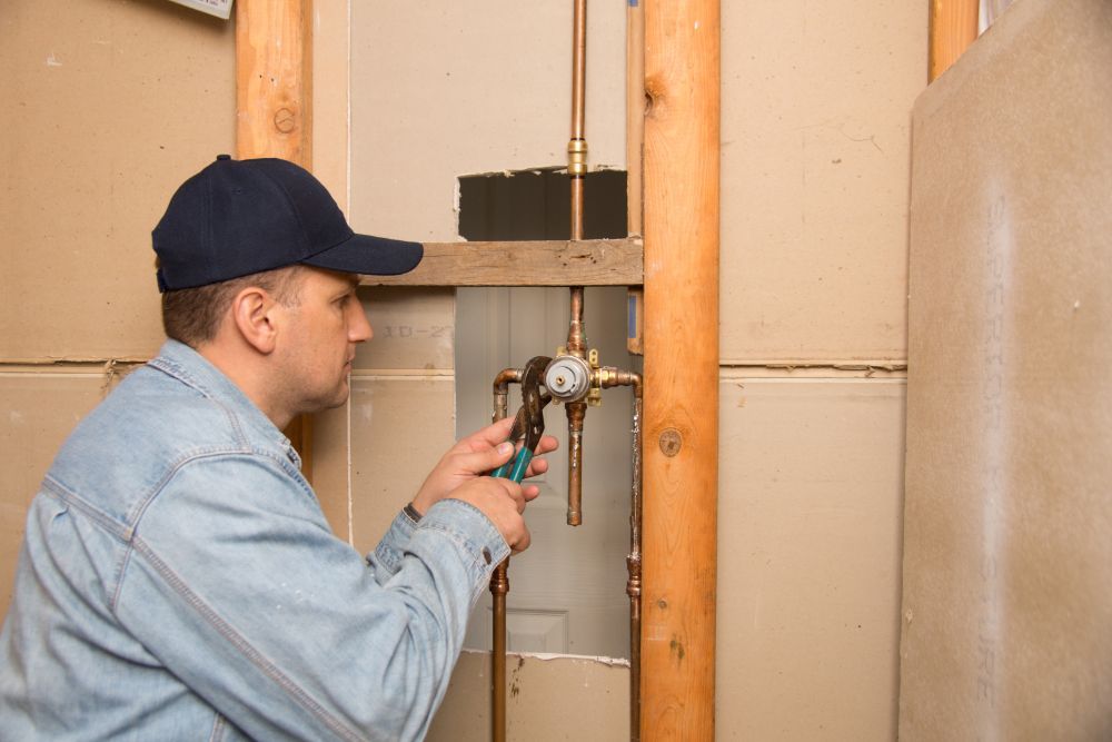 a qualified plumber fixing a water line leak