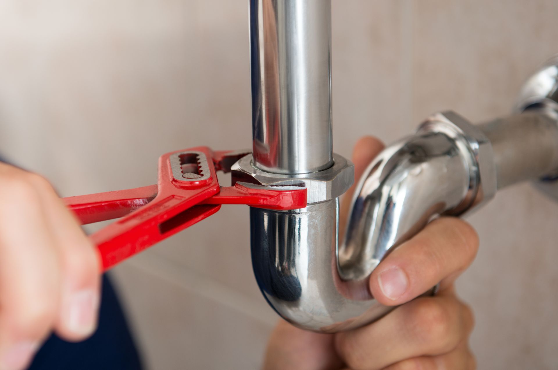 a plumber repairing a drain pipe