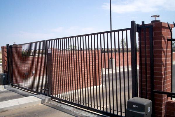 Vinyl Fence — Solid Gate Attached in Brick Walls in Albuquerque, NM