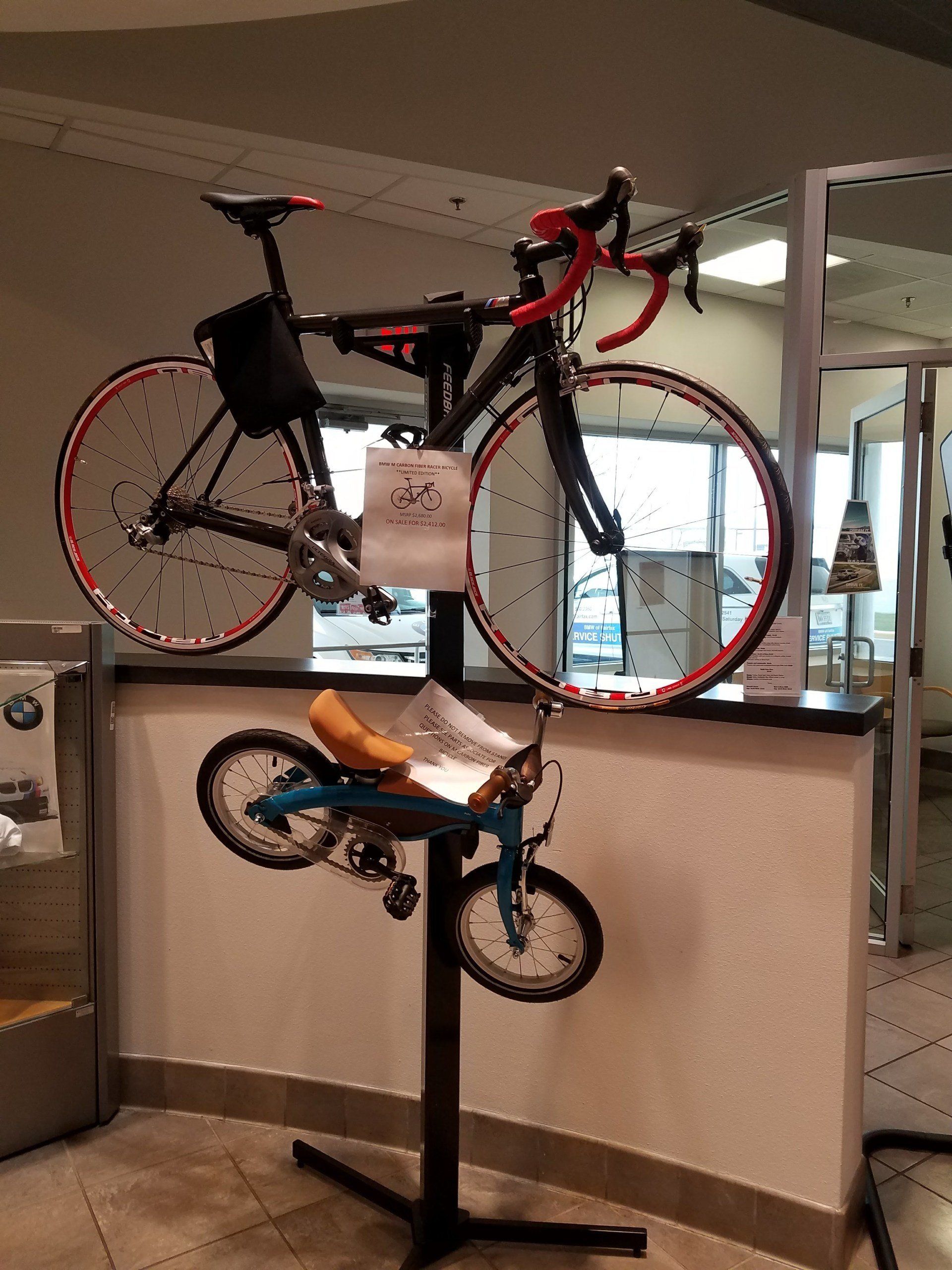 A bicycle is hanging on a stand in front of a counter