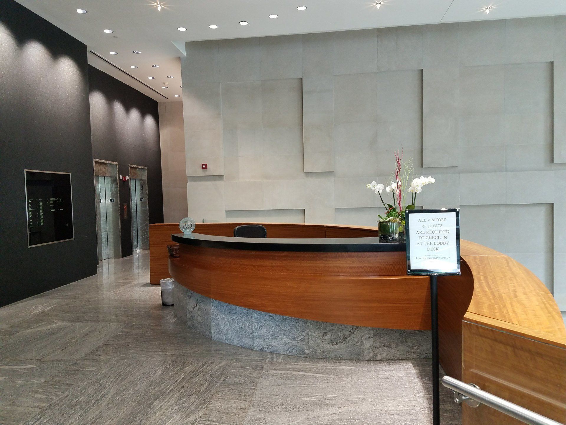 A large lobby with a wooden reception desk